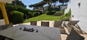 a table and chairs in a backyard with a yard at 7 Ocean Point in Sitio de Calahonda