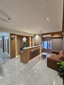 a lobby with a couch and a table in a building at Hotel Royal Heritage in Gandhinagar