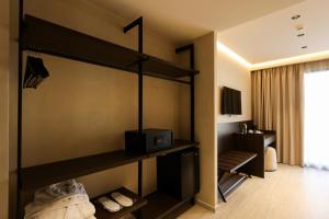 a room with a bed with a microwave on the wall at Safin Hotel & Spa in Vlorë