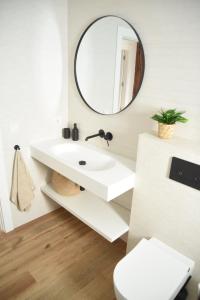 a bathroom with a white sink and a mirror at Villa Casalís in Cubas +37 photos