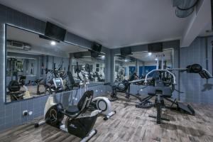 a gym with several treadmills and exercise equipment at Stalis Hotel in Stalís