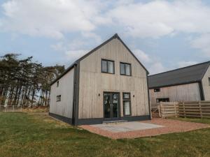 a barn conversion with a black and white at Harvest Cottage 2 in Berwick-Upon-Tweed