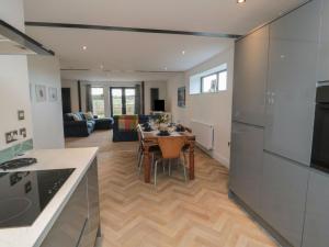 a kitchen and dining room with a table and a living room at Harvest Cottage 2 in Berwick-Upon-Tweed