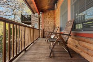 a porch with two chairs and a table on it at Emerson Resort & Spa in Mount Tremper