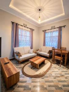a living room with two couches and a coffee table at Jk Suites Karatu in Karatu
