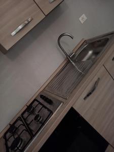 a kitchen counter with a sink and a stove at Arcadia Hosting Aeroporto in Bologna +7 photos