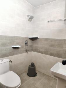 a bathroom with a toilet and a sink at LivShared in Patna +57 photos