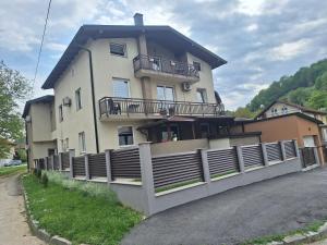 a large house with a fence in front of it at Apartmani Villas in Visoko