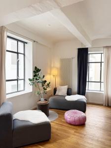 a living room with two beds and a couch at Seven Rooms Hamburg in Hamburg +6 photos