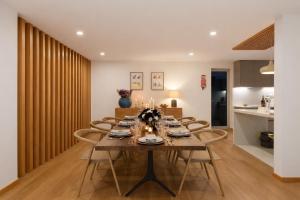 a dining room with a long table and chairs at BUTEKO HOUSE AL in Miranda do Douro