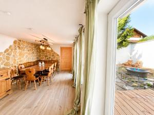 a dining room with a table and a stone wall at Ferienwohnung Resi´s Welfenoase in Schwangau