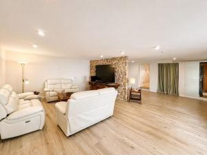 a living room with white furniture and a fireplace at Ferienwohnung Resi´s Welfenoase in Schwangau