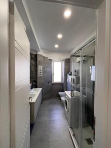 a bathroom with a sink and a washing machine at Brothers house in Genzano di Roma