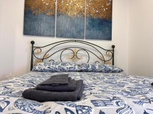 a bed with a blanket and pillows on it at Brothers house in Genzano di Roma