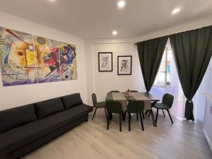 a living room with a couch and a table with chairs at Brothers house in Genzano di Roma