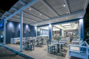 a restaurant with blue walls and tables and chairs at Stalis Hotel in Stalís