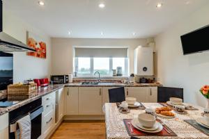 a kitchen with a table with chairs and a sink at 3 Bed in Belford oc-79178 in Belford