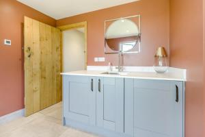 a bathroom with a white sink and a mirror at 3 Bed in Hereford oc-83659 in Madley +24 photos