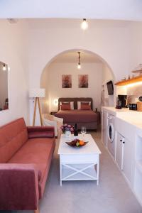 a living room with a couch and a bed and a table at Town Apartment in Mikonos
