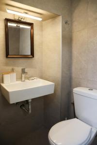 a bathroom with a sink and a toilet at Town Apartment in Mikonos +83 photos