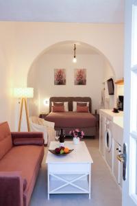 a living room with a bed and a couch at Town Apartment in Mikonos