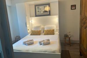 a bedroom with a bed with two pillows on it at Mes Oasis Nancy in Villers-lès-Nancy
