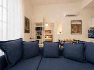 a blue couch with blue pillows in a living room at iPrincipati Luxury Living Suite in Salerno