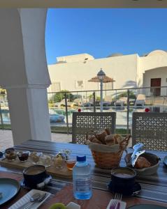 a table with a basket of bread and a basket of water at Menzel Yahia in Houmt Souk +91 photos