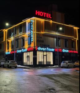 a hotel with cars parked outside of it at night at Divan Tower Otel in Erzurum
