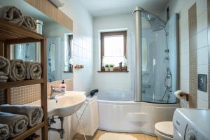 a bathroom with a tub and a sink at 4U Apartments - Zakopane in Zakopane +62 photos