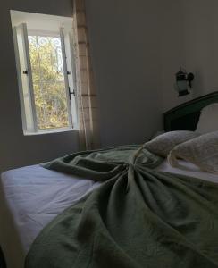 a bedroom with a large bed with a window at Menzel Yahia in Houmt Souk