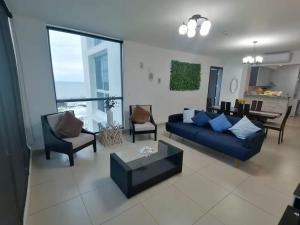 a living room with a blue couch and chairs at Playa Blanca Ocean ll in Playa Blanca