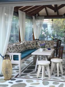 a living room with a couch and a table and chairs at Niriides in Ammouliani