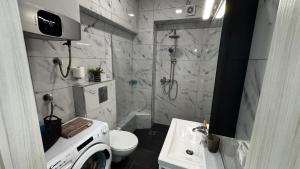 a bathroom with a shower and a toilet and a sink at Bella Luxury Suite III in Paralia Katerinis