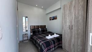 a bedroom with a bed with shoes on it at Bella Luxury Suite III in Paralia Katerinis