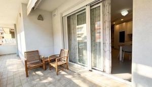 a balcony with two chairs and a table on it at Marco Polo House in Chioggia