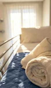 a bed with a towel on top of it at Marco Polo House in Chioggia