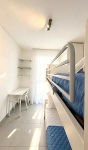 a bedroom with a bunk bed and a table at Marco Polo House in Chioggia +16 photos