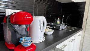 a red mixer on a counter in a kitchen at Bella Luxury Suite III in Paralia Katerinis +3 photos