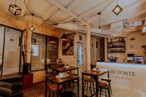 a restaurant with tables and chairs and a bar at Tre Porte Rooms & Bar in Rovinj