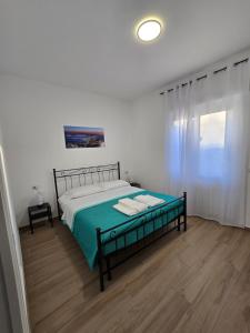 a bedroom with a bed with a green blanket at DOMUS AISA appartamenti Formia centro in Formia