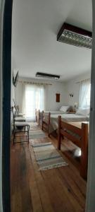 a room with two beds and a table in it at Hospedaje por 7 días 15 dias o Mes in La Serena