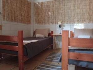 a bedroom with two beds and a desk in it at Hospedaje por 7 días 15 dias o Mes in La Serena