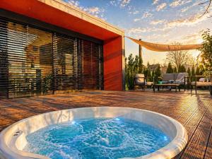 a hot tub on the deck of a house at Casa Luba in Saulkrasti