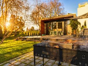 a barbecue grill in front of a house at Casa Luba in Saulkrasti