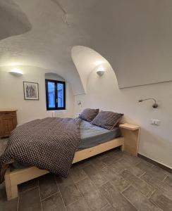 a bedroom with a bed in an attic at Residence by Talking Stones in Dolceacqua