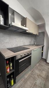 a kitchen with a sink and a stove top oven at Residence by Talking Stones in Dolceacqua