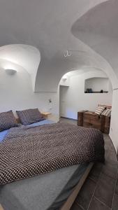 a bedroom with a large bed in a room at Residence by Talking Stones in Dolceacqua