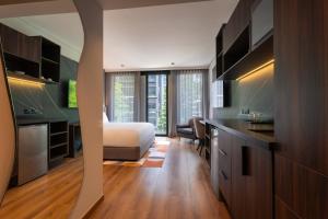 a bedroom with a bed and a desk in a room at Ambulan Mexico City in Mexico City