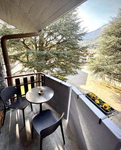 a table and chairs on a balcony with a view at Mont-Blanc Design Studio in Morgex